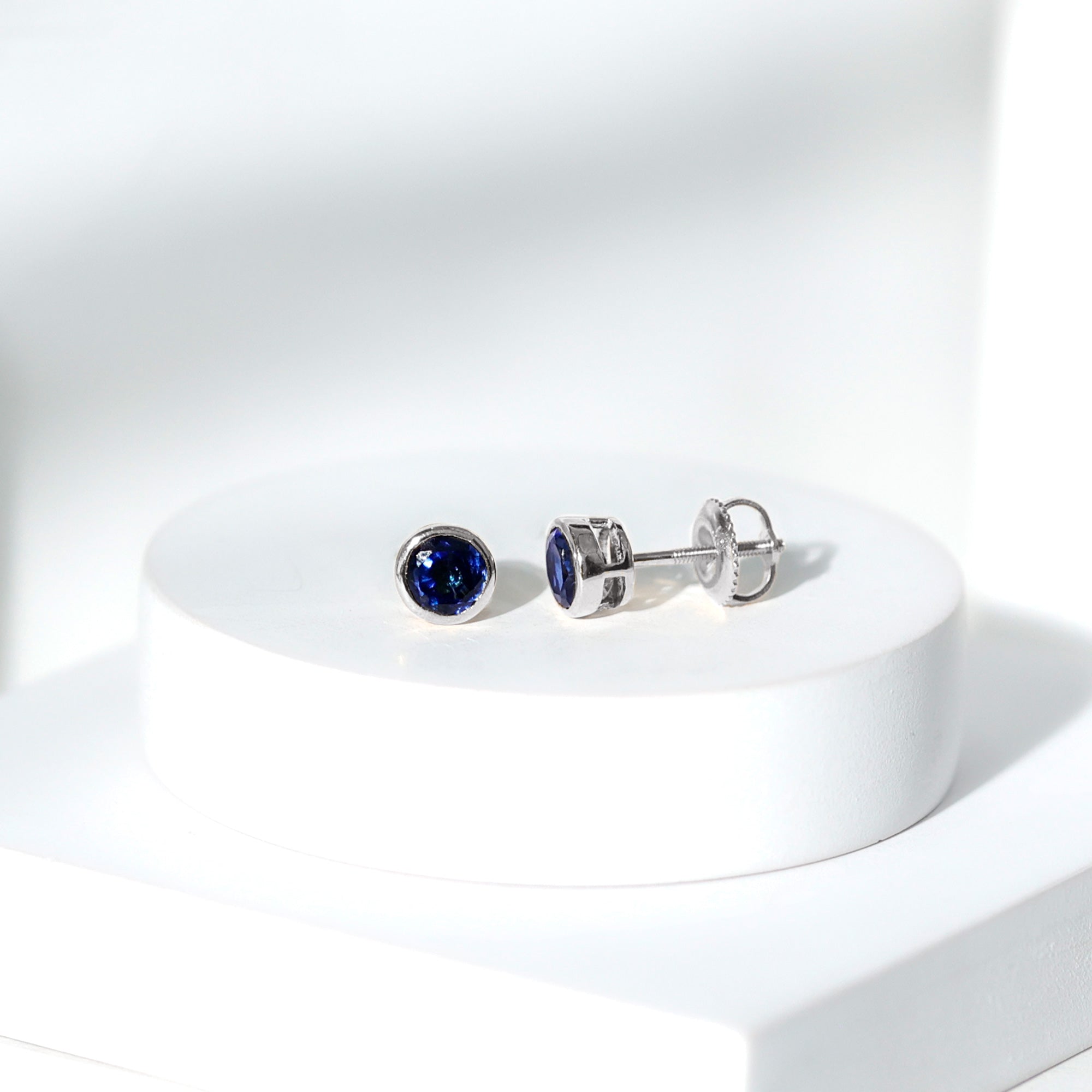 Rosec Jewels-Bezel Set Lab Grown Blue Sapphire Stud Earrings With Screw Back