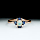 Rosec Jewels-Ethiopian Opal Engagement Ring with Blue Sapphire and Moissanite